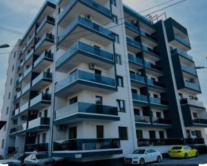 an apartment building with cars parked in front of it at Serin Blaxy Studio in Mangalia