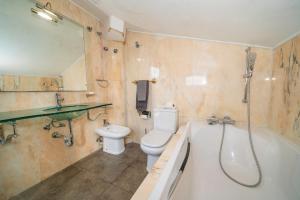 Un baño con bañera, inodoro y lavabo. en Casa Bohème, en Santa Susanna 70 fotos más