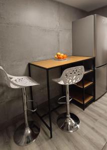 a table with two chairs and a table with fruit on it at ALEJANDRO PLAYA Gandia 1 in Los Mártires