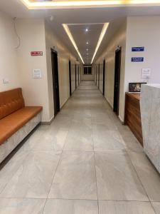 an empty hallway in a building with a couch at SV Banquets And Luxury Rooms in Farrukhnagar