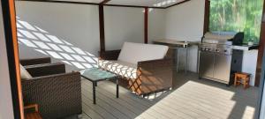 a balcony with a chair and a table and a stove at Apartma Panorama in Žusterna