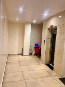 an empty hallway with a tile floor in a building at SV Banquets And Luxury Rooms in Farrukhnagar
