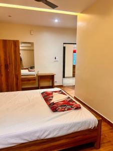 a bedroom with a bed and a table in a room at SV Banquets And Luxury Rooms in Farrukhnagar