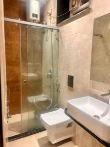 a bathroom with a shower and a toilet and a sink at SV Banquets And Luxury Rooms in Farrukhnagar