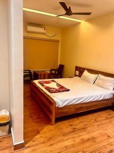 a bedroom with a bed with a ceiling fan at SV Banquets And Luxury Rooms in Farrukhnagar