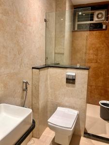 a bathroom with a toilet and a sink at SV Banquets And Luxury Rooms in Farrukhnagar