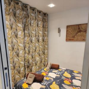 a bed with two pillows on it in a room at Appartement Cosy en plein centre historique de Fréjus in Fréjus