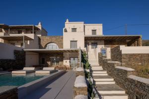 a house with a swimming pool next to a building at casa elysian in Agios Romanos