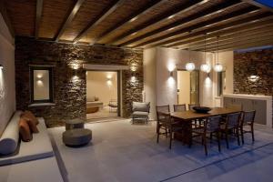 a kitchen and dining room with a table and chairs at casa elysian in Agios Romanos