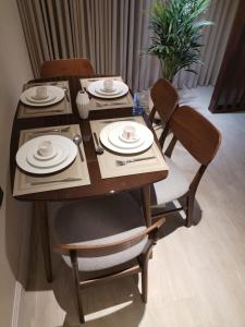 a dining room table with chairs and plates on it at بارك سويت Park Suite in Riyadh