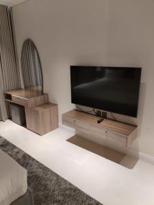 a living room with a flat screen tv on a stand at بارك سويت Park Suite in Riyadh