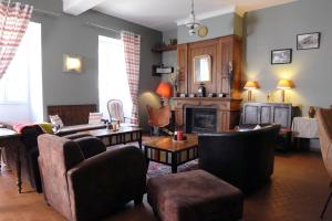 a living room filled with furniture and a fireplace at Maison CHILO in Barcus