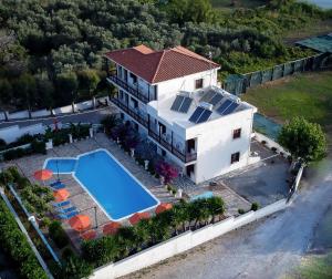 een luchtfoto van een huis met een zwembad bij Apartments Dimitra in Kámpos