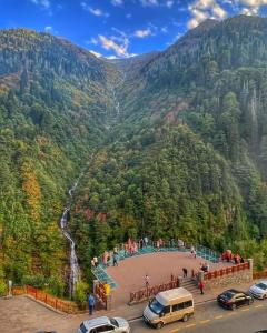 a view of a mountain with cars parked in front at Aydere Apart Hotel in Ayder Yaylasi