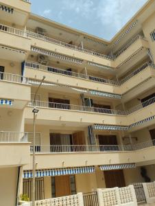 a large building with balconies on the side of it at ALEJANDRO PLAYA Gandia 1 in Los Mártires