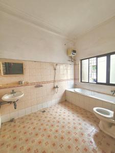 a bathroom with a tub and a toilet and a sink at Morri Homestay - Quán Thánh in Hanoi +80 photos