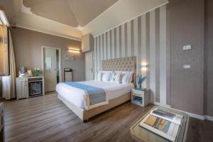 a bedroom with a large white bed and a table at Hotel Metropole in Santa Margherita Ligure