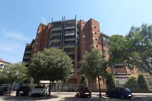 a tall building with cars parked in front of it at Casa Olimpia 52 in Verona