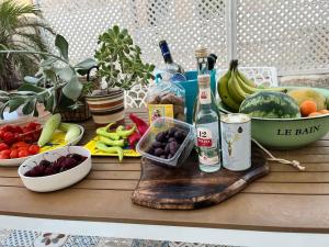 a table with fruits and vegetables and bottles of alcohol at Colibri seafront villa with pool in Nopíyia