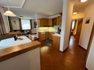 a kitchen with wooden cabinets and a white counter top at Ferienwohnung Webhofer in Außervillgraten