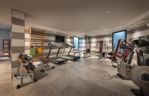 a gym with several treadmills and machines in a room at Hotel Metropole in Santa Margherita Ligure