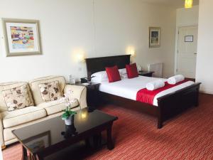 
a living room with a couch, coffee table and a lamp at Park Central Hotel in Bournemouth
