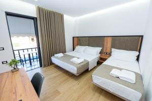 Postel nebo postele na pokoji v ubytování Kevin's ApartHotel