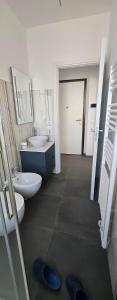 a bathroom with two sinks and two toilets in it at Forte2110 in Misano Adriatico