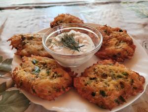 a plate of food with a bowl of dipping sauce at Casa Georgeta 2 Mai-Punct Gastronomic Local-AROME DOBROGENE in 2 Mai