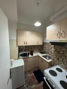 a small kitchen with a stove and a sink at Plaka quiet Apartment in Athens