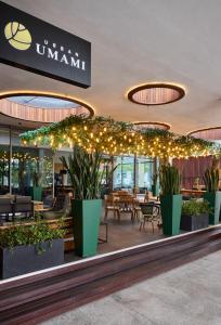 a restaurant with plants and lights in a building at Century City Hotel Urban Square in Cape Town