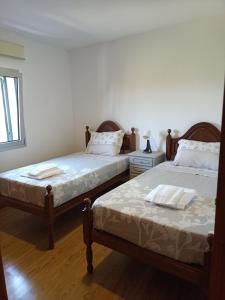 a bedroom with two beds and a window at Retiro Da Montanha - Gerês in Geres