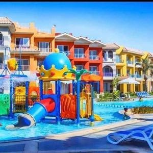 a playground in a pool with a water park at Porto Matroh Eid in Marsa Matruh +3 photos
