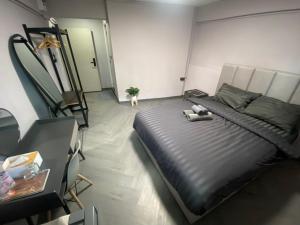 a bedroom with a bed with a stuffed animal on it at Inntown in Amphoe Phra Khanong +6 photos