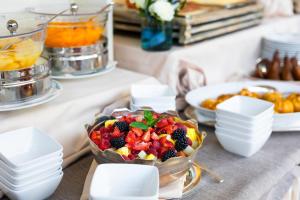 a buffet of fruit salad in a bowl on a table at Hotel Metropole in Santa Margherita Ligure