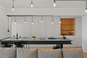 a kitchen with a large table and a couch at RHUM B03 - Dome View in Bucharest +33 photos