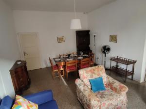 a living room with a table and a dining room at Populonia corso apartment in Populonia