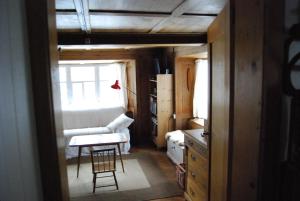 a room with a couch and a table and a chair at Bergbauernhaus an Wasserfall und Waldrand in Schwändi