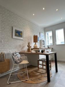 a dining room with a table and a chair at Retour des Indes in Lorient +49 photos
