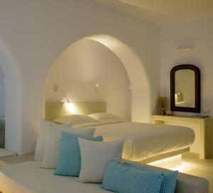a bedroom with a large bed with a mirror at Mykonos Moussa in Agios Ioannis Mykonos