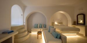 a bedroom with two beds and two windows at Mykonos Moussa in Agios Ioannis Mykonos