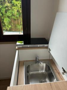 a sink in a kitchen with a window at Luminoso alloggio sul mare in Cattolica +8 photos