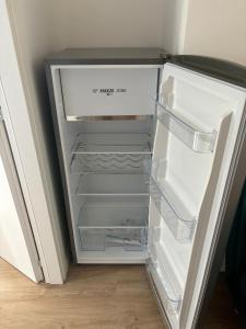 an empty refrigerator with its door open in a room at Luminoso alloggio sul mare in Cattolica