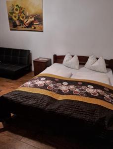 a bedroom with a bed with a blanket on it at Smestaj Novakovic ,Zdrelo in Ždrelo