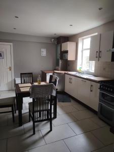 a kitchen with a table and chairs and a table and a table and a kitchen at stay wise in Dublin