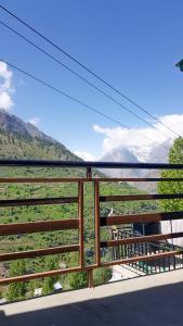 a balcony with a view of a mountain range at Pine Corn Guest House in Kyelang