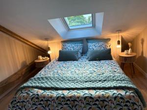 a bedroom with a large bed with a window at L'arbre de soie Futuroscope Acacia in Vouillé