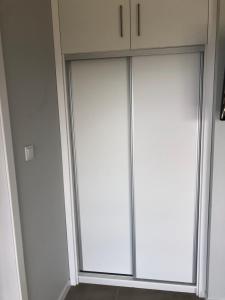 two sliding glass doors in a room at Casa da Baía da Feteira in Lajes do Pico