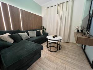 a living room with a couch and a table at Oasis Apartment 1 by GG in Alexandroupoli