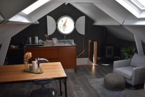 a living room with a table and a chair at van Harte in Zeeland in Kamperland